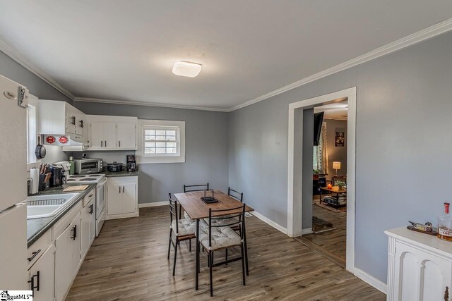 123 Cobb St, Easley, SC 29640 - kitchen featuring crown molding, electric stove, white cabinets, and dark wood-type flooring