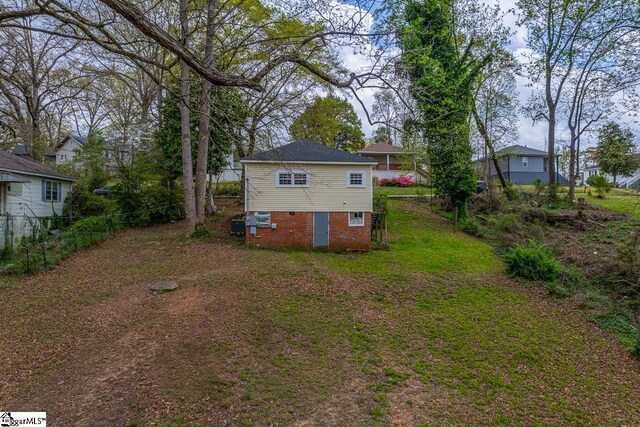 123 Cobb St, Easley, SC 29640 - rear view of property with a lawn and fence