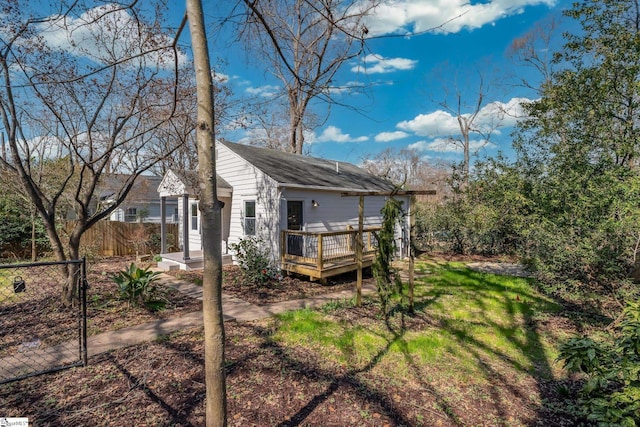back of property featuring fence and a deck