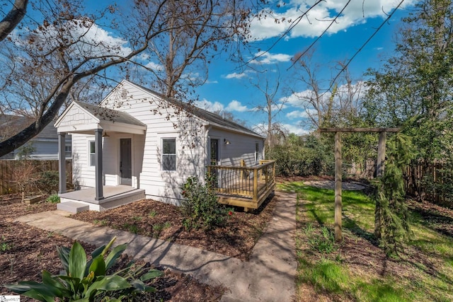 view of front of house featuring fence and a deck