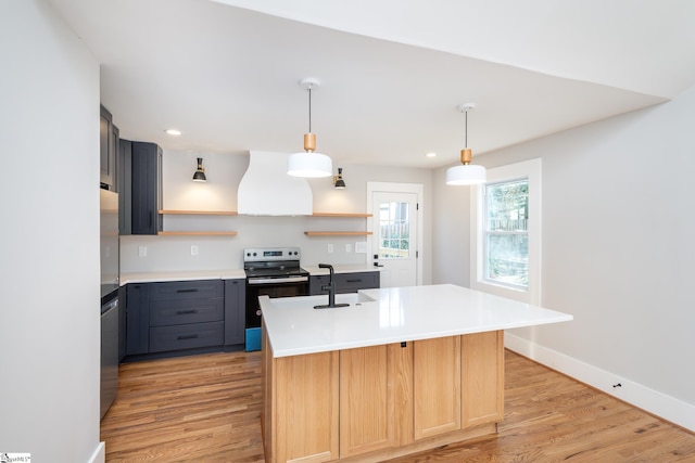kitchen featuring open shelves, extractor fan, stainless steel appliances, light wood finished floors, and light countertops