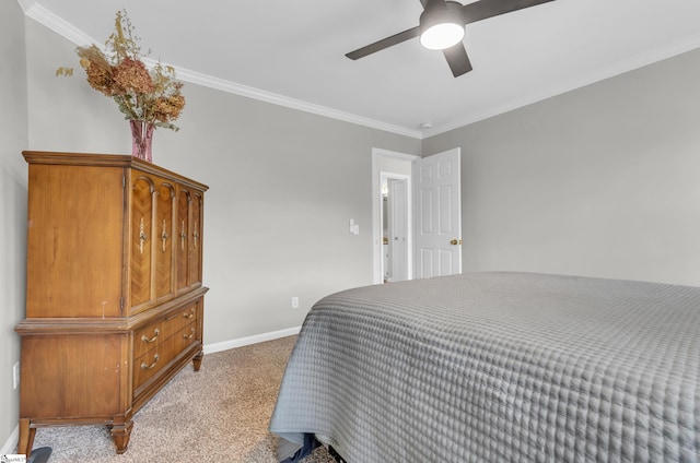 carpeted bedroom with baseboards, ceiling fan, and ornamental molding