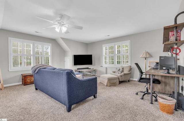 carpeted living room with a wealth of natural light, baseboards, and a ceiling fan