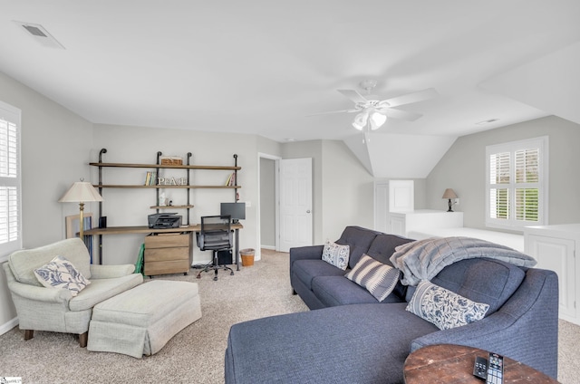 carpeted living area with baseboards, visible vents, ceiling fan, and a healthy amount of sunlight