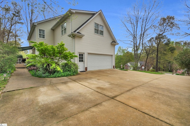 view of property exterior with brick siding, driveway, and an attached garage