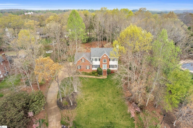 birds eye view of property featuring a view of trees