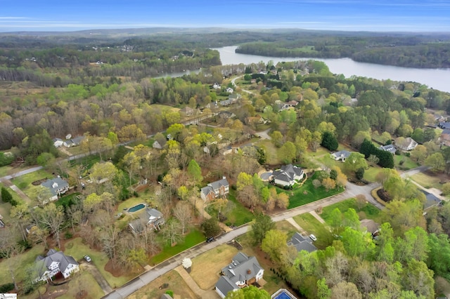 drone / aerial view with a water view and a view of trees