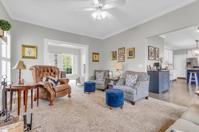 living room featuring ornamental molding, wood finished floors, and a ceiling fan