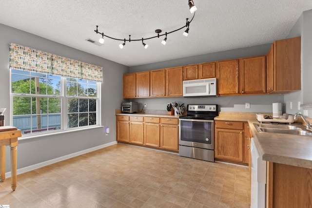 29 Parkgate Ct, Simpsonville, SC 29680 - kitchen with white appliances, a sink, brown cabinets, and a textured ceiling