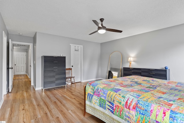 29 Parkgate Ct, Simpsonville, SC 29680 - bedroom featuring light wood finished floors, baseboards, a textured ceiling, and a ceiling fan