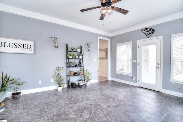 foyer entrance with baseboards, ceiling fan, and ornamental molding