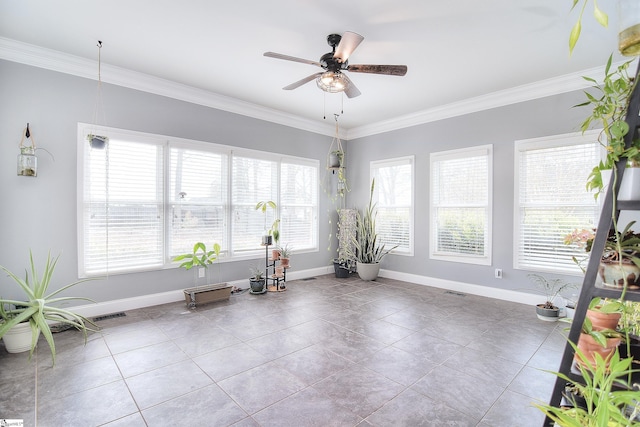 unfurnished room with crown molding, baseboards, and ceiling fan
