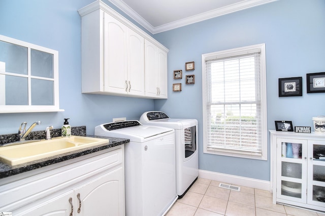 laundry room featuring crown molding, separate washer and dryer, light tile patterned flooring, a sink, and visible vents