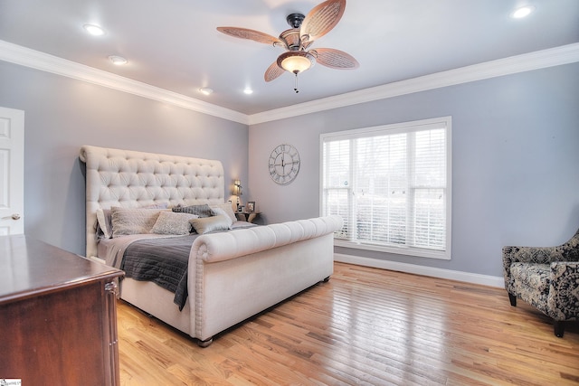 bedroom with a ceiling fan, crown molding, baseboards, and light wood finished floors