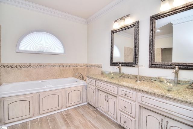 full bath featuring wood tiled floor, crown molding, a sink, and a garden tub