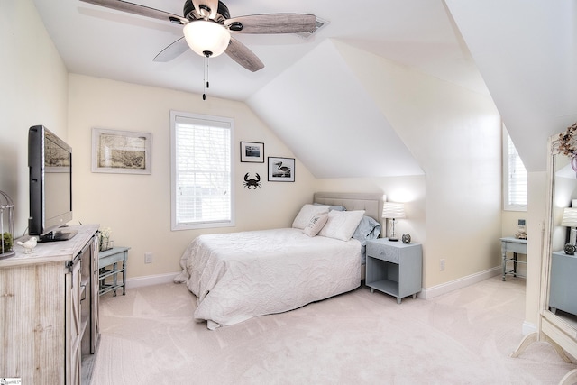 bedroom with baseboards, lofted ceiling, light colored carpet, and ceiling fan