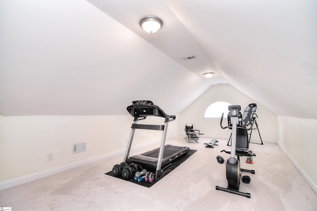 workout area featuring baseboards, visible vents, lofted ceiling, and carpet floors