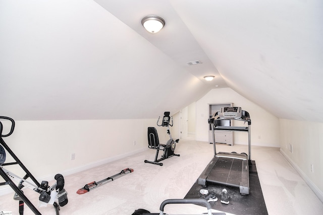 exercise room with carpet flooring, baseboards, lofted ceiling, and visible vents