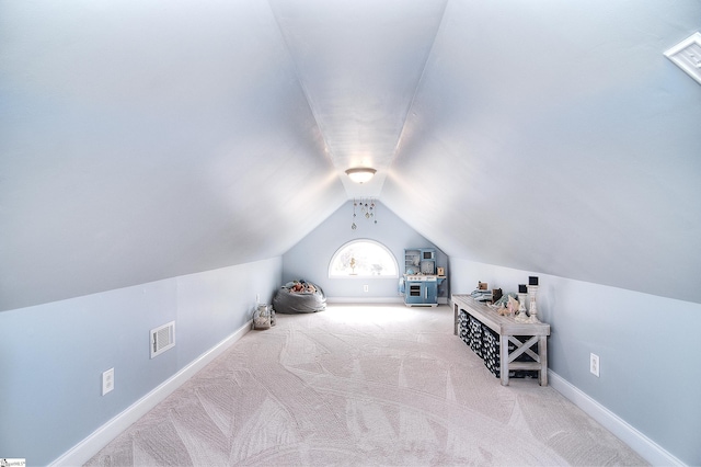 additional living space with baseboards, lofted ceiling, visible vents, and carpet floors