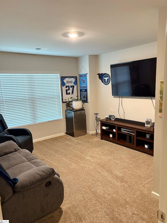 living room featuring baseboards, visible vents, and carpet floors
