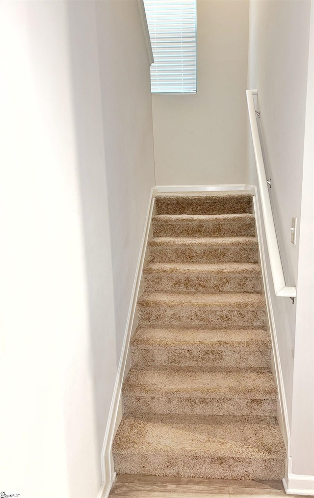 staircase featuring baseboards