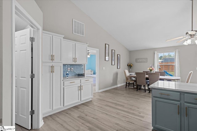 22 Kavanagh Ct, Greenville, SC 29611 - kitchen featuring ceiling fan, tasteful backsplash, light wood-style floors, and visible vents