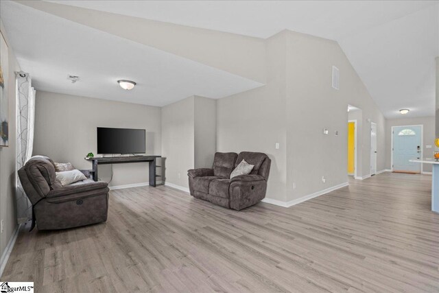 22 Kavanagh Ct, Greenville, SC 29611 - living room with light wood-style floors, lofted ceiling, and baseboards