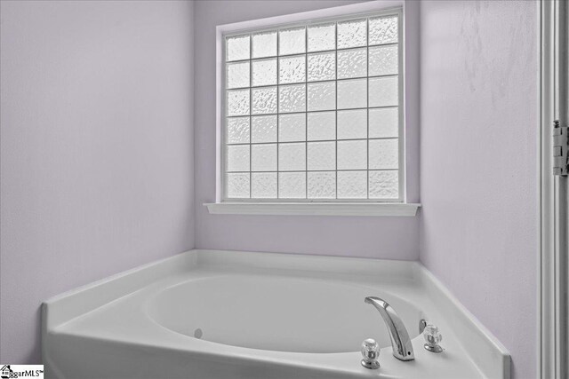 22 Kavanagh Ct, Greenville, SC 29611 - bathroom with a garden tub and a wealth of natural light