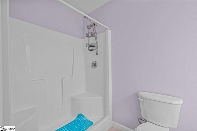 22 Kavanagh Ct, Greenville, SC 29611 - bathroom featuring baseboards, toilet, and a shower