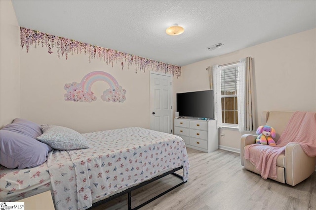 22 Kavanagh Ct, Greenville, SC 29611 - bedroom featuring light wood finished floors, baseboards, visible vents, and a textured ceiling