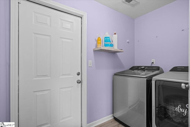 22 Kavanagh Ct, Greenville, SC 29611 - laundry area featuring washing machine and clothes dryer, light wood-style flooring, baseboards, visible vents, and laundry area