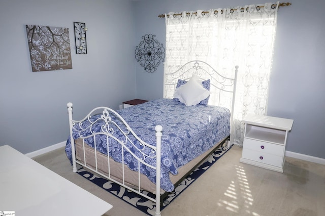 bedroom with carpet floors and baseboards