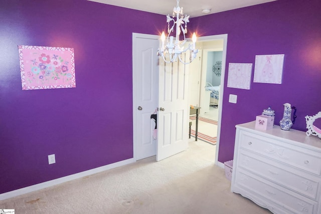 bedroom with light colored carpet, baseboards, and a chandelier
