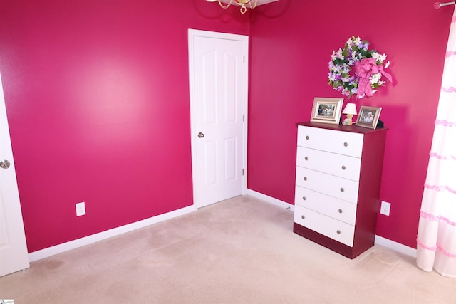 unfurnished bedroom with baseboards and light colored carpet