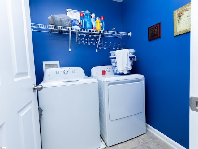 laundry room with separate washer and dryer, baseboards, and laundry area