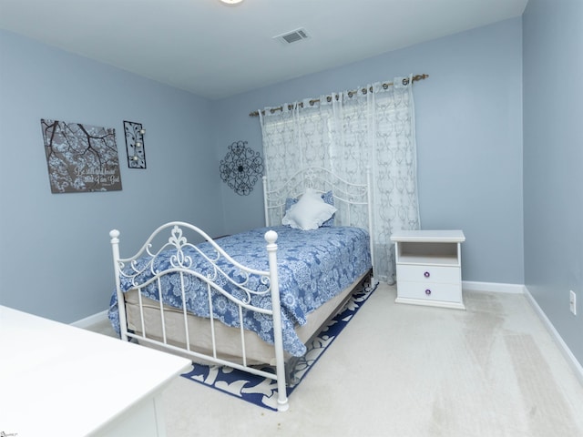 carpeted bedroom with baseboards and visible vents