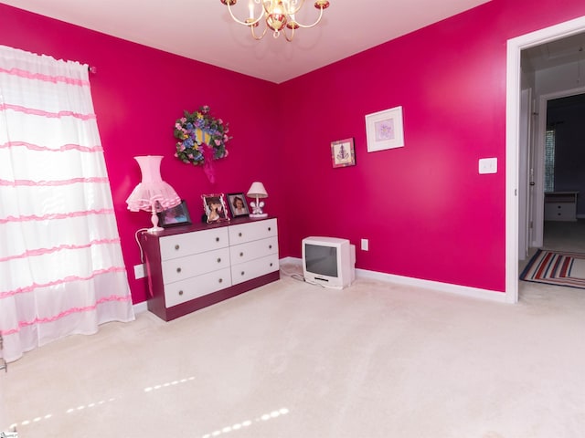 bedroom with baseboards, an inviting chandelier, and carpet