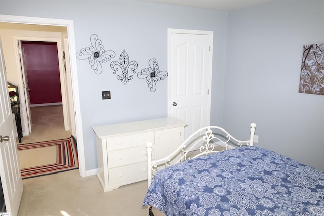 carpeted bedroom with baseboards