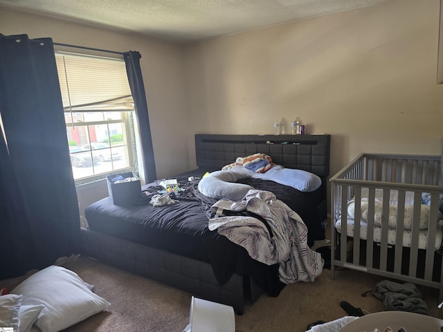 carpeted bedroom featuring a textured ceiling