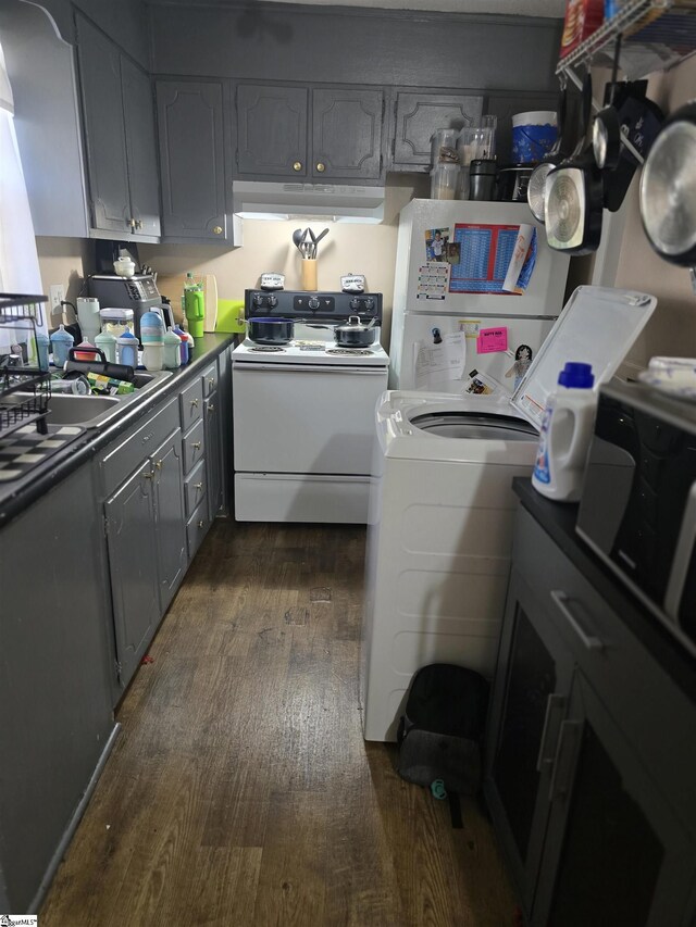 laundry area with laundry area, dark wood finished floors, and washer / clothes dryer