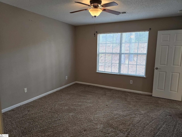 unfurnished room featuring a ceiling fan, carpet floors, baseboards, and a textured ceiling