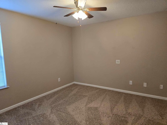unfurnished room featuring baseboards, carpet floors, a textured ceiling, and a ceiling fan