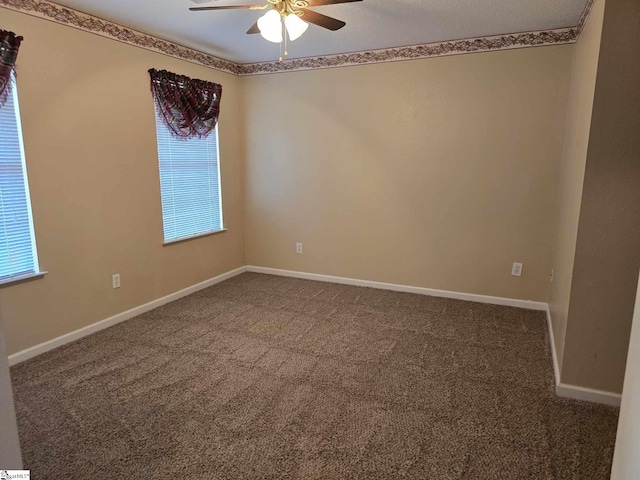 empty room with baseboards, carpet floors, and a ceiling fan