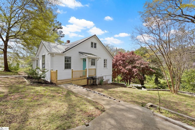 305 Morse St, Pendleton, SC 29670 - view of front of house with a chimney, a front yard, and metal roof