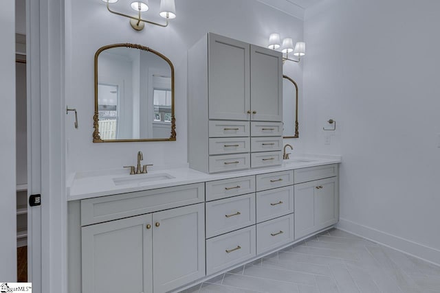 bathroom featuring double vanity, baseboards, and a sink