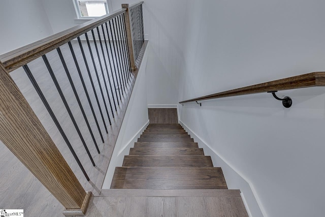 stairs featuring wood finished floors