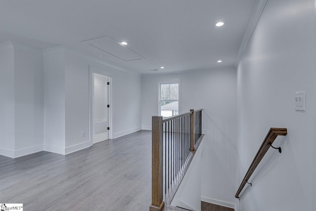stairway with ornamental molding, recessed lighting, wood finished floors, attic access, and baseboards