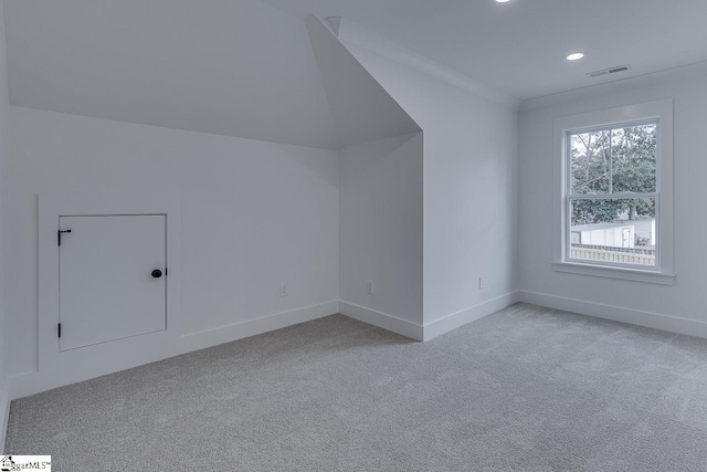 additional living space with recessed lighting, visible vents, light colored carpet, and baseboards