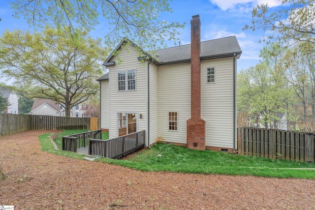 rear view of house with crawl space, a yard, a fenced backyard, a chimney, and a shingled roof