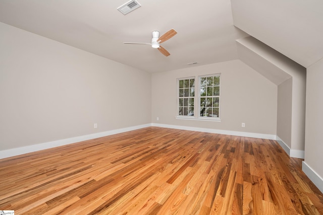 bonus room with wood finished floors, baseboards, a ceiling fan, and visible vents